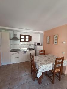 a kitchen and dining room with a table and chairs at CASA FELISA in Pola de Somiedo