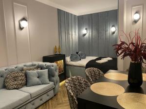 a living room with a couch and a table at Family & Business Sauna Tężnia Apartments No14 Leśny nad Zalewem Cedzyna - 1 Bedroom with Private Sauna, Bath with Hydromassage , Terrace, Parking, Catering Options in Kielce +72 photos