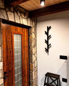 a room with a door and a stool next to a wall at Mount House Mavrovo in Mavrovo +42 photos