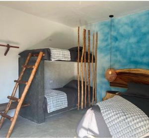 a bedroom with two bunk beds and a ladder at Luna Rossa in El Paredón Buena Vista