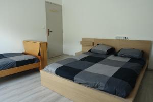 a bedroom with two beds and a closet at Tout un 2eme étage à 300 mètres de la mer, chez l'habitant ! in Fécamp