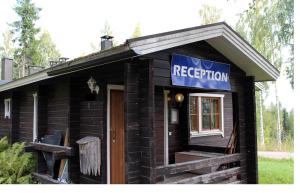 a log cabin with a sign that reads registration at Riihilintu Villa in Muurame