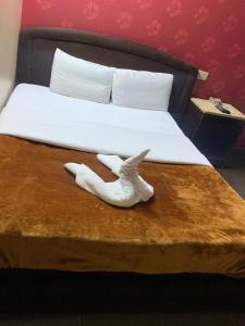 a pair of white shoes sitting on a bed at Kerotel Egypt in Cairo