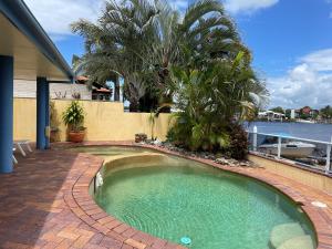 a small swimming pool in a patio with trees and water at SPECTACULAR WATERFRONT Canal Home, BRIBIE ISLAND in Banksia Beach