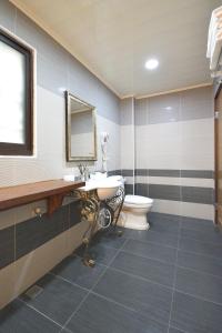 a bathroom with a sink and a toilet at Ji Li Ya Lan Homestay in Chenggong