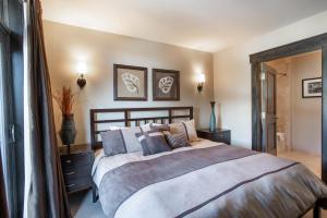 a bedroom with a large bed with pillows at Spacious Village View Townhouse with Fireplace at Parry Peak Lofts townhouse in Winter Park