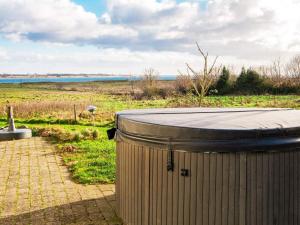 a large trash can sitting on a brick walkway at 24 person holiday home in Haderslev in Årøsund