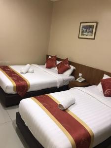 A bed or beds in a room at Hotel Zamburger Lamb Special