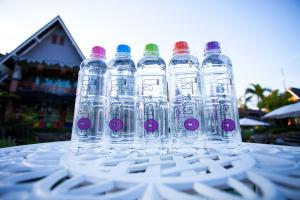 a group of water bottles sitting on top of a table at Is Am O Chiang Mai Resort in San Sai