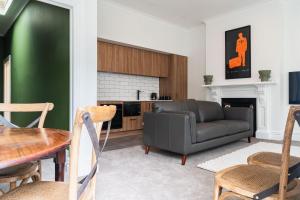 a living room with a couch and a table at Premium Living on Stuart St in Dunedin