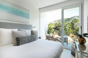 a bedroom with a white bed and a large window at Casa Elevar at Orchid in Puerto Vallarta +45 photos