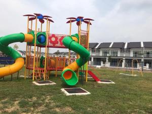 a playground with a colorful slide in a park at BEDONG GOLF VILLA in Bedung