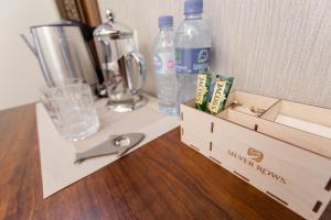 a table with two wooden boxes with water bottles at Hotel Silver Rows in Samarkand