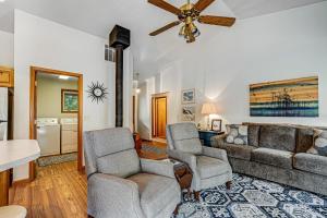 a living room with a couch and two chairs at Three Capes Cottage in Pacific City