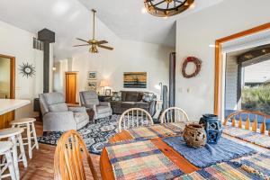 a dining room and living room with a table and chairs at Three Capes Cottage in Pacific City +23 photos