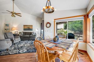 a dining room with a table and chairs and a couch at Three Capes Cottage in Pacific City