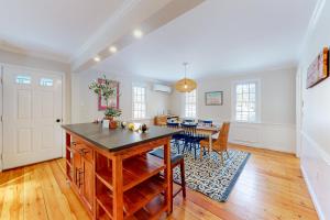 a kitchen with a table and a dining room at Just Beachy in Kennebunk