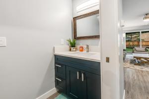 a bathroom with a sink and a mirror at SurfSide in Westport +21 photos