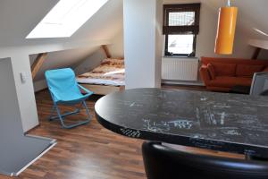 a room with a table and a chair and a bed at Ferienwohnung Bergisch Land in Wermelskirchen