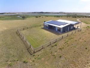 an overhead view of a house with solar panels on it in a field at Coorong Island Retreat - Farm Stay at Pet Friendly Property in Meningie