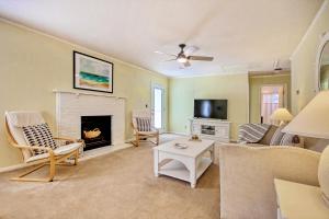 a living room with a couch and a fireplace at Holden onto Sunshine in Holden Beach