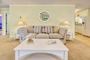 a living room with a couch and a table at Holden onto Sunshine in Holden Beach