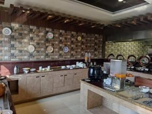 a large kitchen with a counter in a kitchen at Vivanta Jamshedpur, Golmuri in Jamshedpur