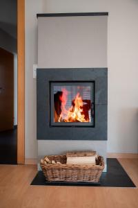 a fireplace with a fire in a living room at Bergleben Maria Alm - Haus Panorama in Maria Alm am Steinernen Meer