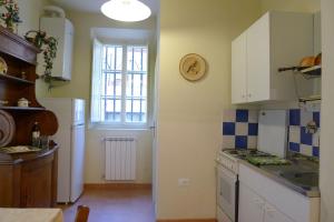 a kitchen with a white refrigerator and a window at Gioberti Beccaria in Florence