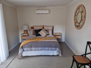a bedroom with a bed and two night stands at Historic Mintaro Post Office in Mintaro