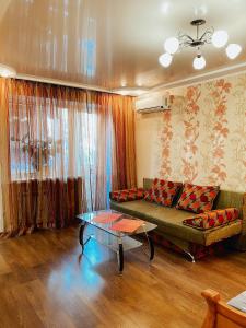 a living room with a couch and a table at Apartment - Sobornyi Prospekt 97 in Zaporozhye
