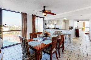 a dining room and kitchen with a table and chairs at Mainsail 334 in Destin