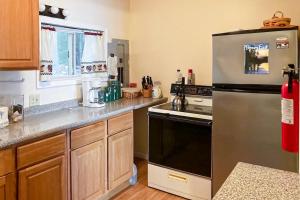 a kitchen with a stainless steel refrigerator and a stove at SunRise Pines in Leeds