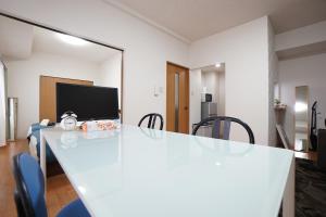 een kamer met een tafel met stoelen en een spiegel bij 豊水すすきの駅から徒歩数分 IK Minami 6 Jo Residence 101 IK南6条レジデンス in Sapporo