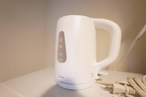 a white appliance sitting on top of a counter at 長期割引 豊水すすきの駅からすぐ IK Minami 6 Jo Residence 803 IK南6条レジデンス in Sapporo
