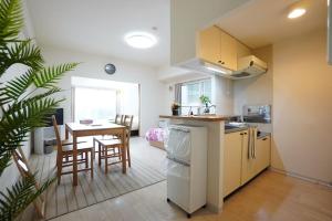 a kitchen and dining room with a table and chairs at 長期割引 豊水すすきの駅からすぐ IK Minami 6 Jo Residence 803 IK南6条レジデンス in Sapporo