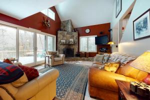 a living room with a couch and a fireplace at The Ski Haus in Jackson