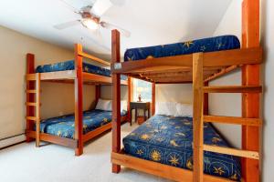 two bunk beds in a room with a ceiling at The Ski Haus in Jackson