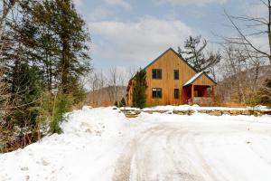 a house in the snow with a dirt road at The Ski Haus in Jackson