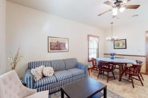 a living room with a couch and a table at Sip & Stay in Fredericksburg