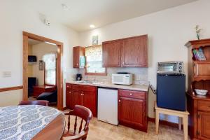 a kitchen with wooden cabinets and a blue refrigerator at Sip & Stay in Fredericksburg
