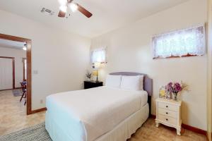 a bedroom with a white bed and a window at Sip & Stay in Fredericksburg