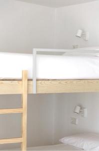 a bunk bed with a light on top of it at Apartamentos Camping Coroso in Ribeira