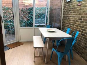a table and chairs in a room with a brick wall at Twickes Townhouse in London
