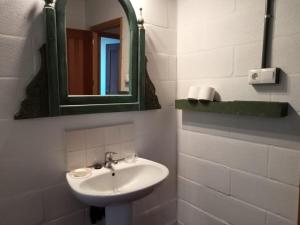 a bathroom with a sink and a mirror at La Bodega de Villa Bella in Espartinas