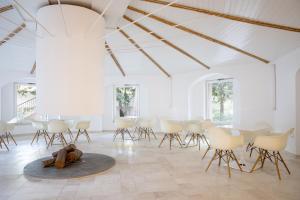 a room with chairs and a teddy bear on the floor at Tirreno Resort in Cala Liberotto