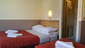 a hotel room with a bed with towels on it at Westholme Hotel in Blackpool