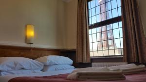 a bedroom with two beds and a window at Westholme Hotel in Blackpool