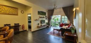 a living room with a couch and a table at Gerard's "Backpackers" Roomstay No Children Adults only in Cameron Highlands