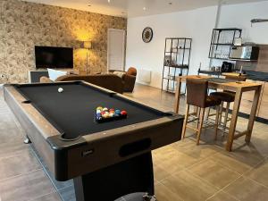 a living room with a pool table in a room at Bleu Horizon in Quiberville